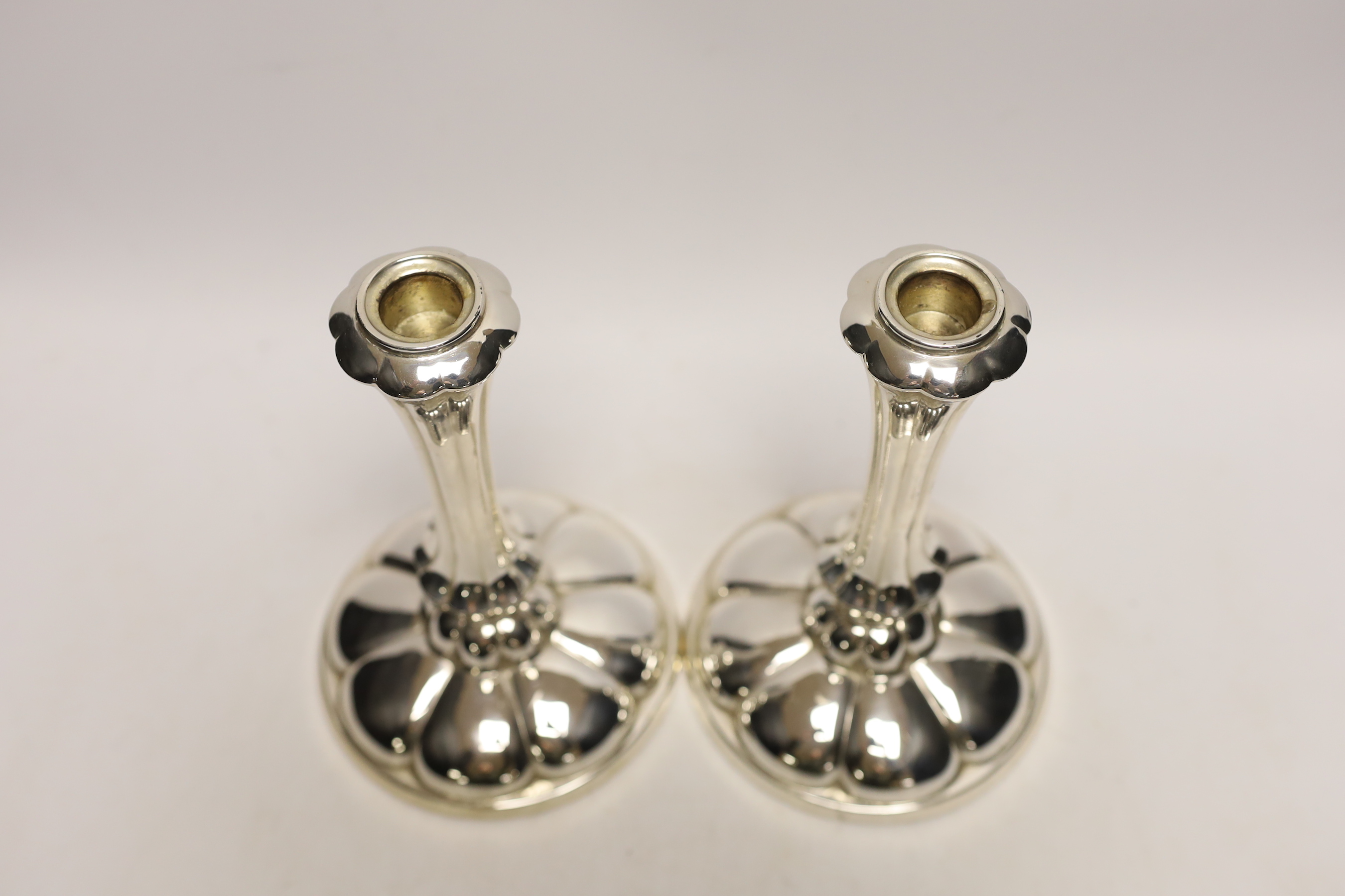 A pair of early 20th century German 800 white metal mounted fluted design candlesticks by Gayer & Krauss, height 20.3cm, weighted.